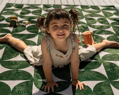 Non-toxic foam baby play mat in modern mid-century design – dark green and neutral tones in family living room